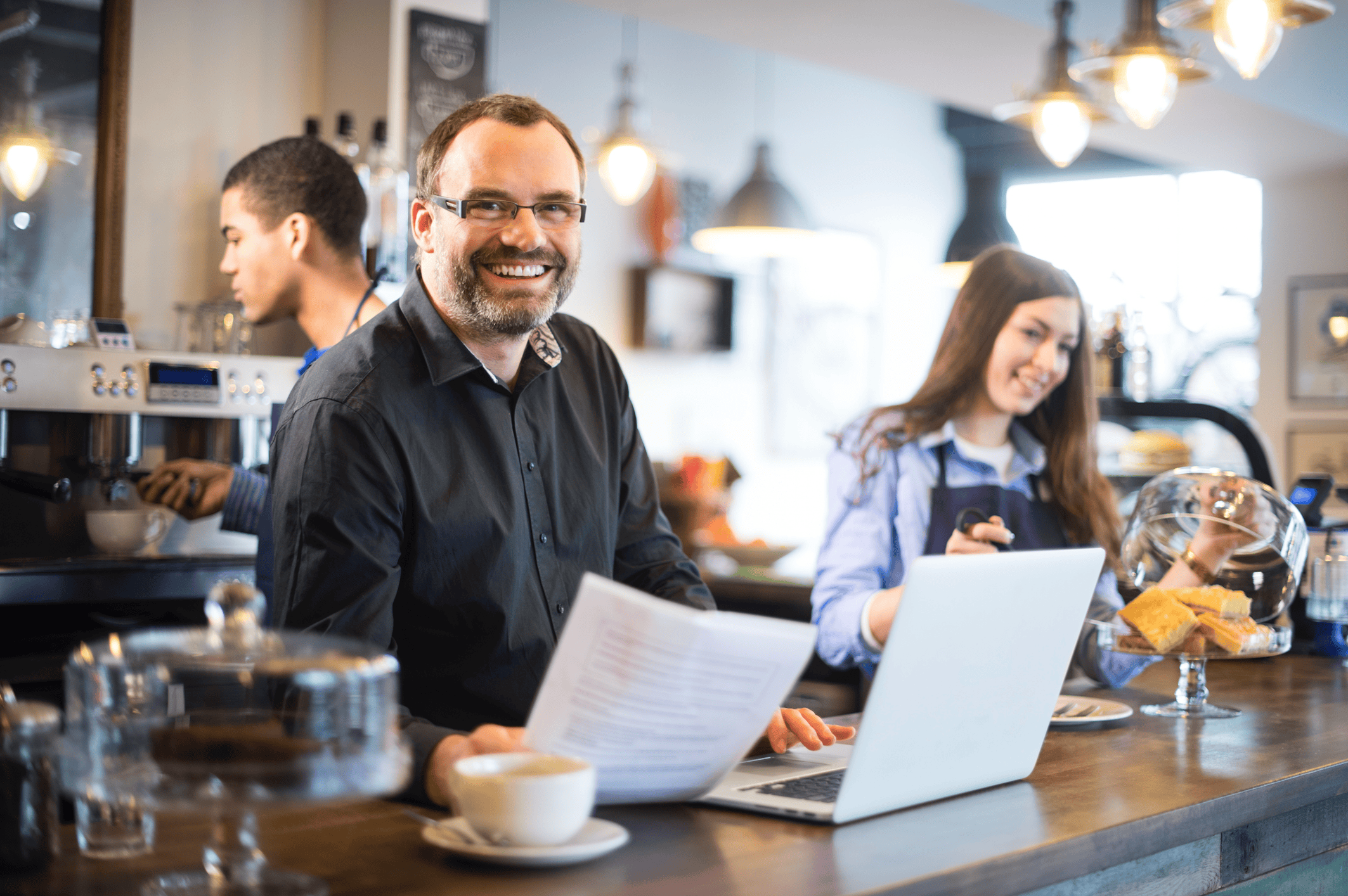 Image of a happy Cafe Restaurant Business Owner in a modern office business owner receiving Monthly Cash Rewards from iSmart Payments
