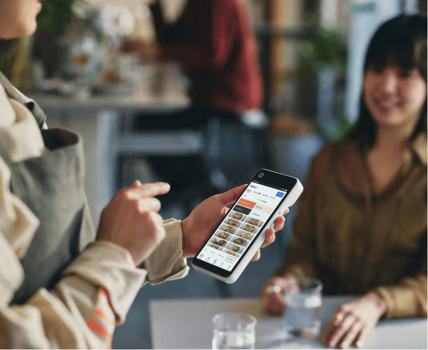 Image of a Square Handheld POS with Customer from iSmart Payments